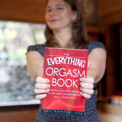 Sex Coach Amy Cooper holdin her book